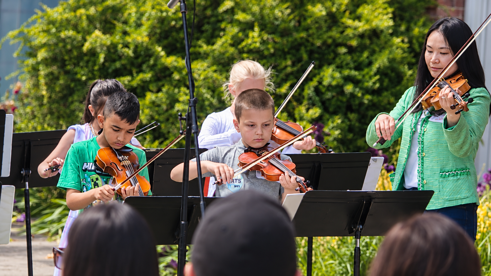 Young violinists performing in front of crowds